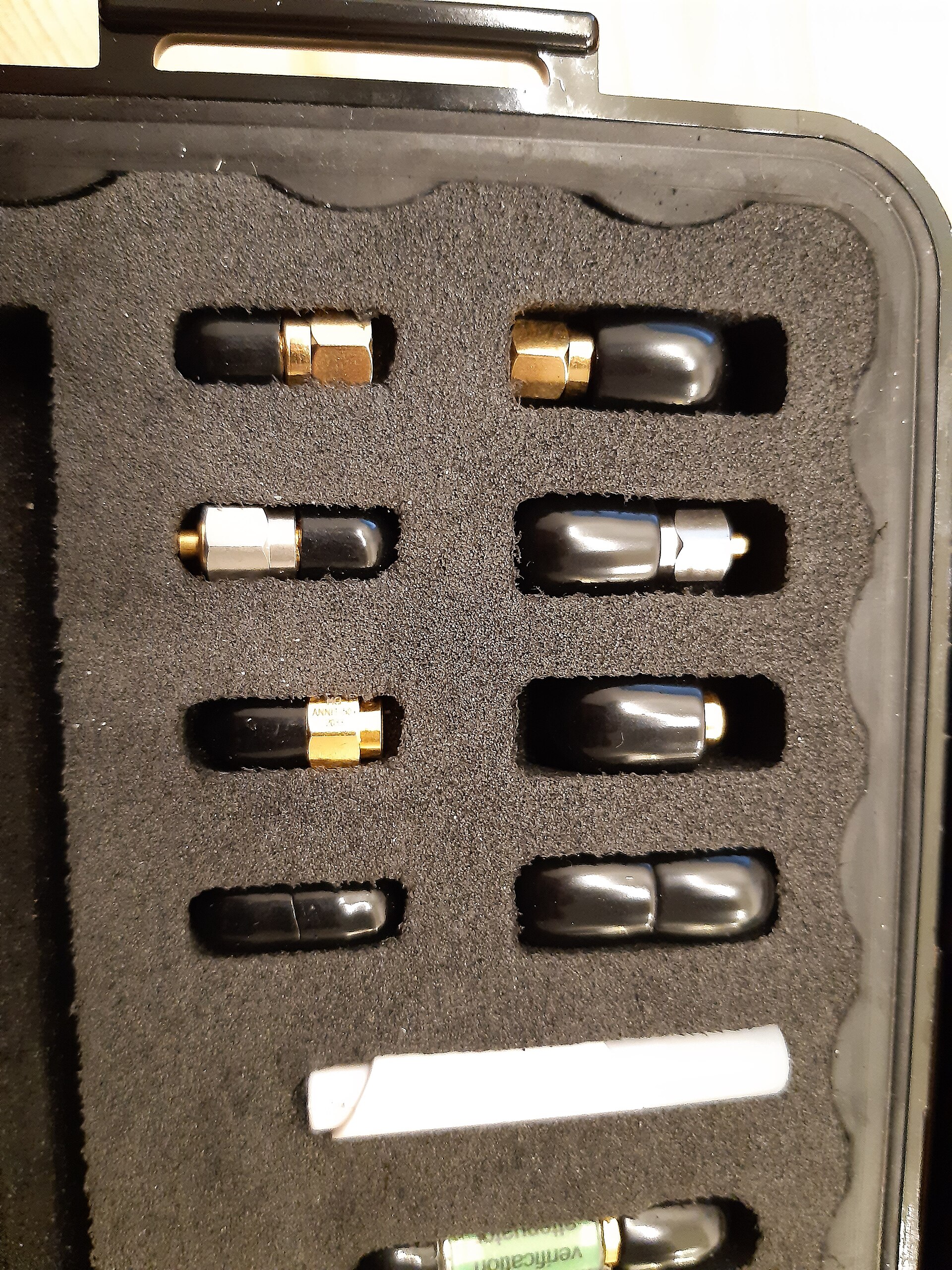 Figure 1 — An SMA open/short/load calibration kit in its padded carrying case — the individual standards (plus male/female pairs for two-port work) a NanoVNA's OSL routine solves against. Photo: "SMA calibrat…
