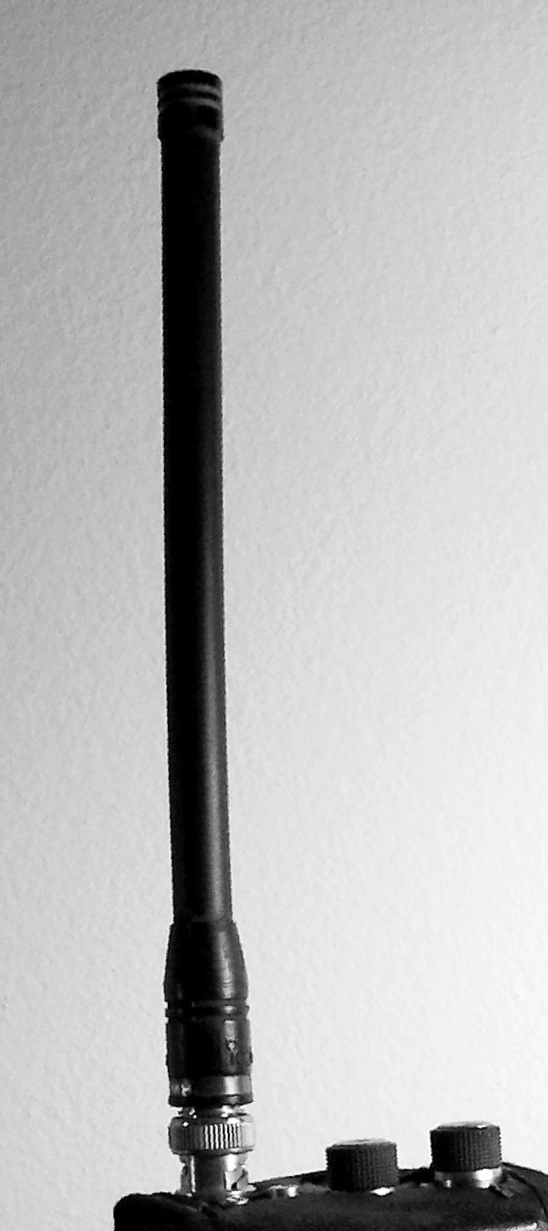 Figure 1 — A stock rubber duck antenna on a handheld radio — a springy helix of wire under a rubber sleeve, the compromise antenna at the center of this volume's argument. Photo: File:RDuckyAntenna.jpg by Lym…